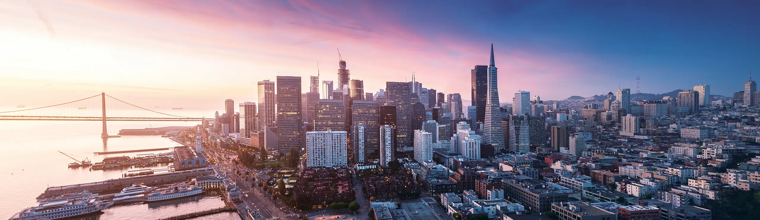 San Francisco skyline with view of the bay, bridges, and maritime vessels