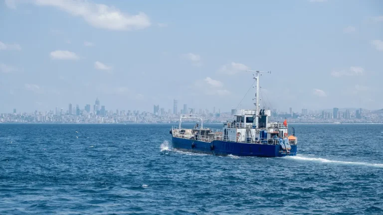 Commercial fishing boat navigating rough ocean waves