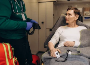 Cruise passenger receiving first aid from ship medical crew after accident.