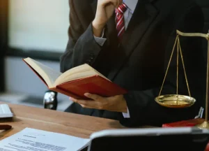 Lawyer or judge reviewing legal documents with nautical charts and papers, representing maritime law, salvage operations, and key legal authorities.